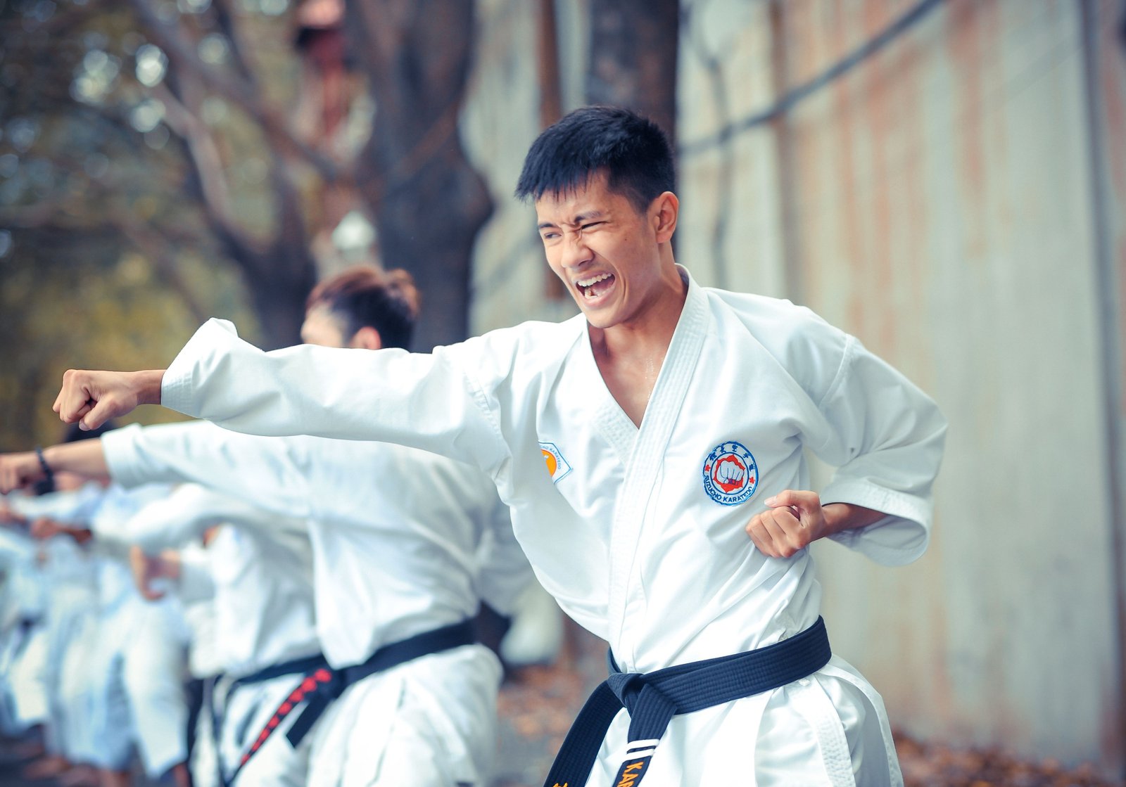 Sensei Arjun Mehta leading a karate class in a white gi
